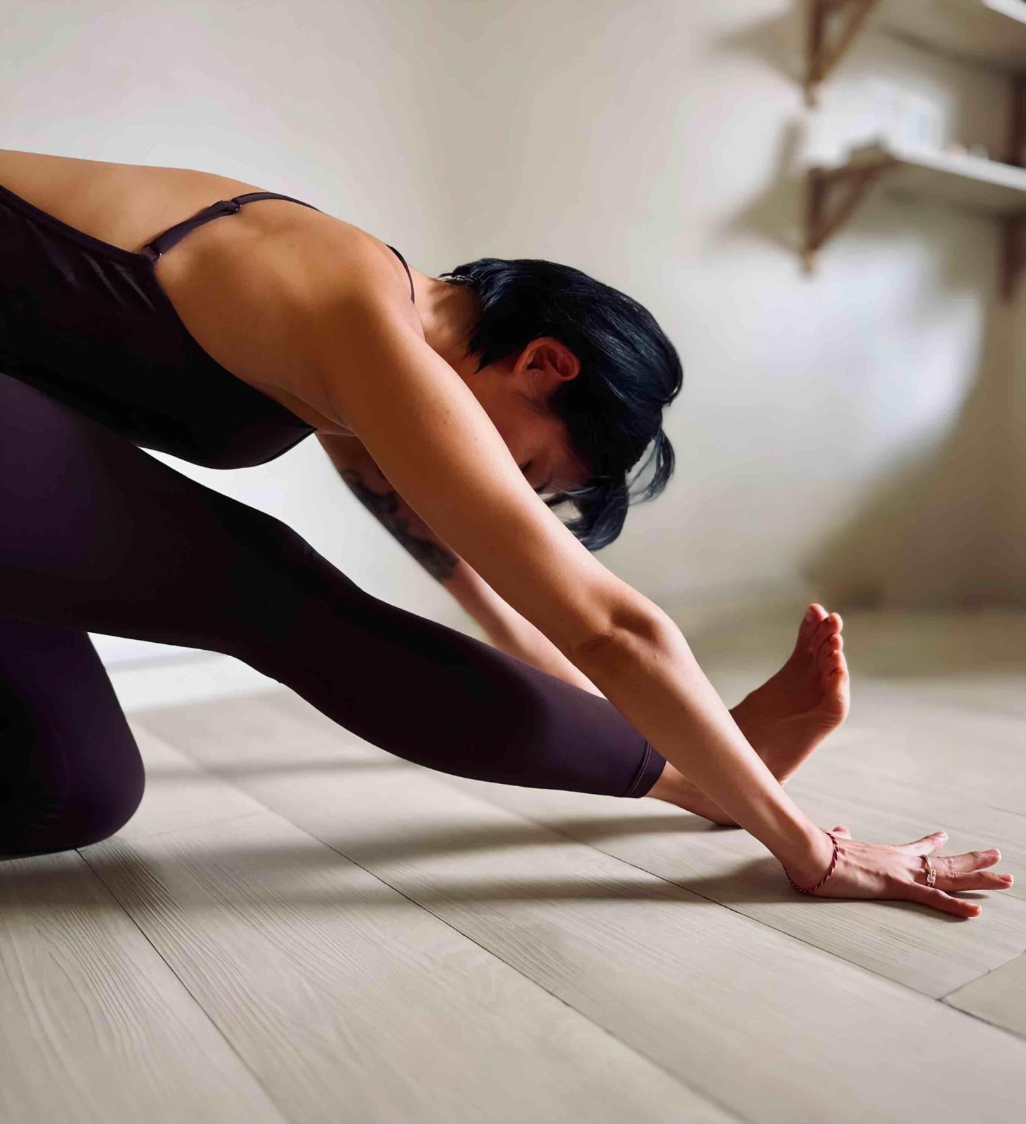 Tiffany Ann Chow seated, calm and strong, in a tiled corridor
